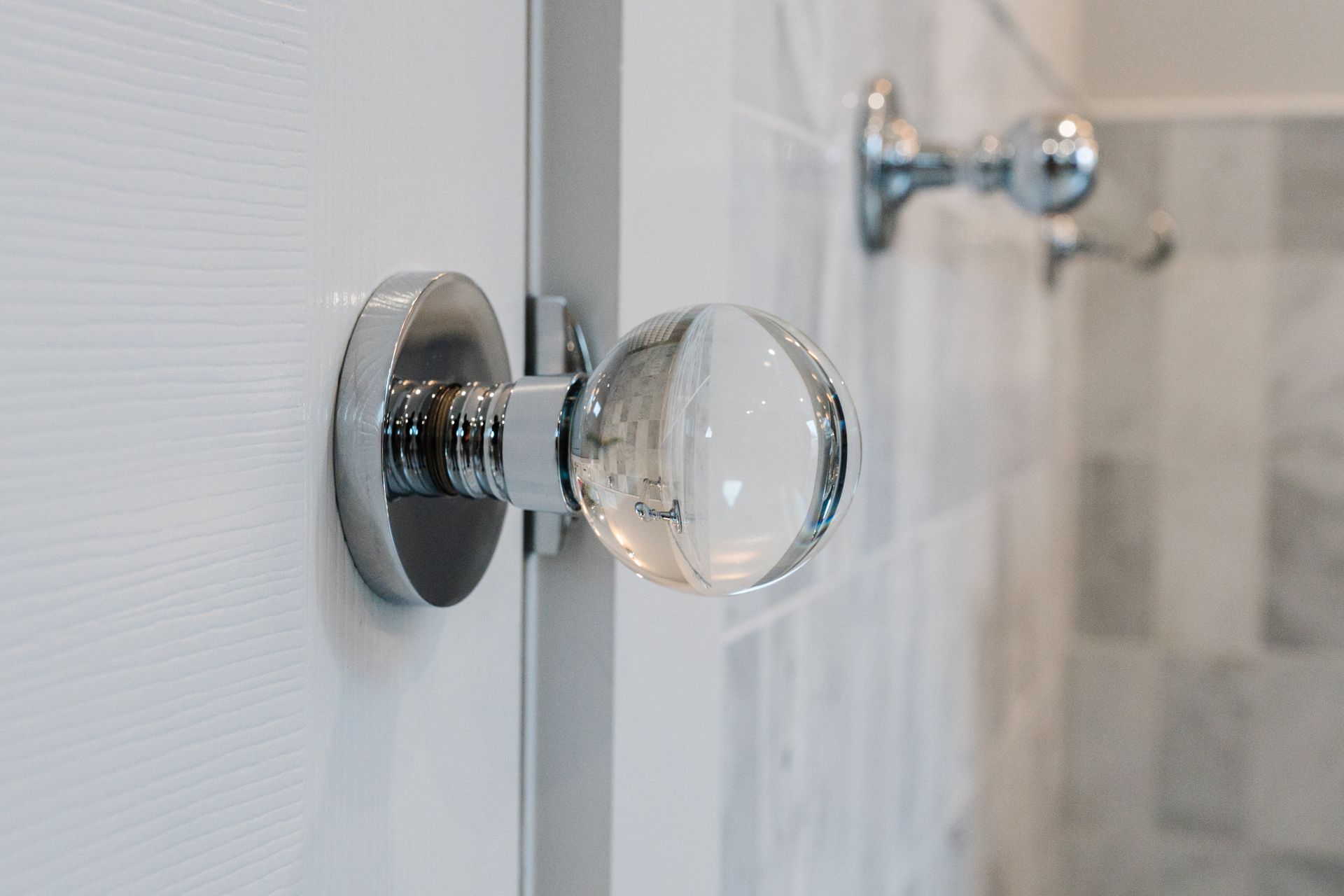 A close up of a door knob on a white door.