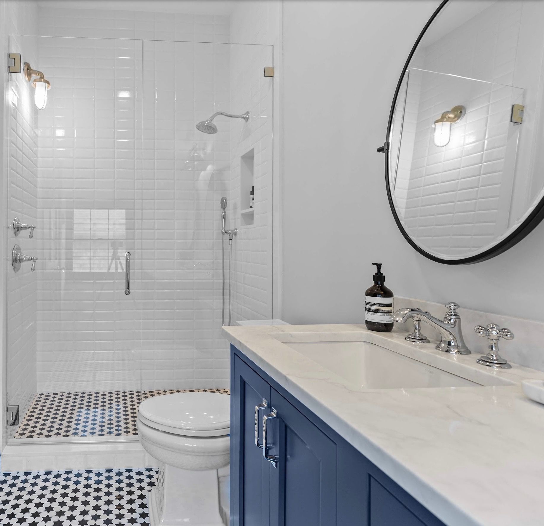 A bathroom with a toilet a sink and a mirror