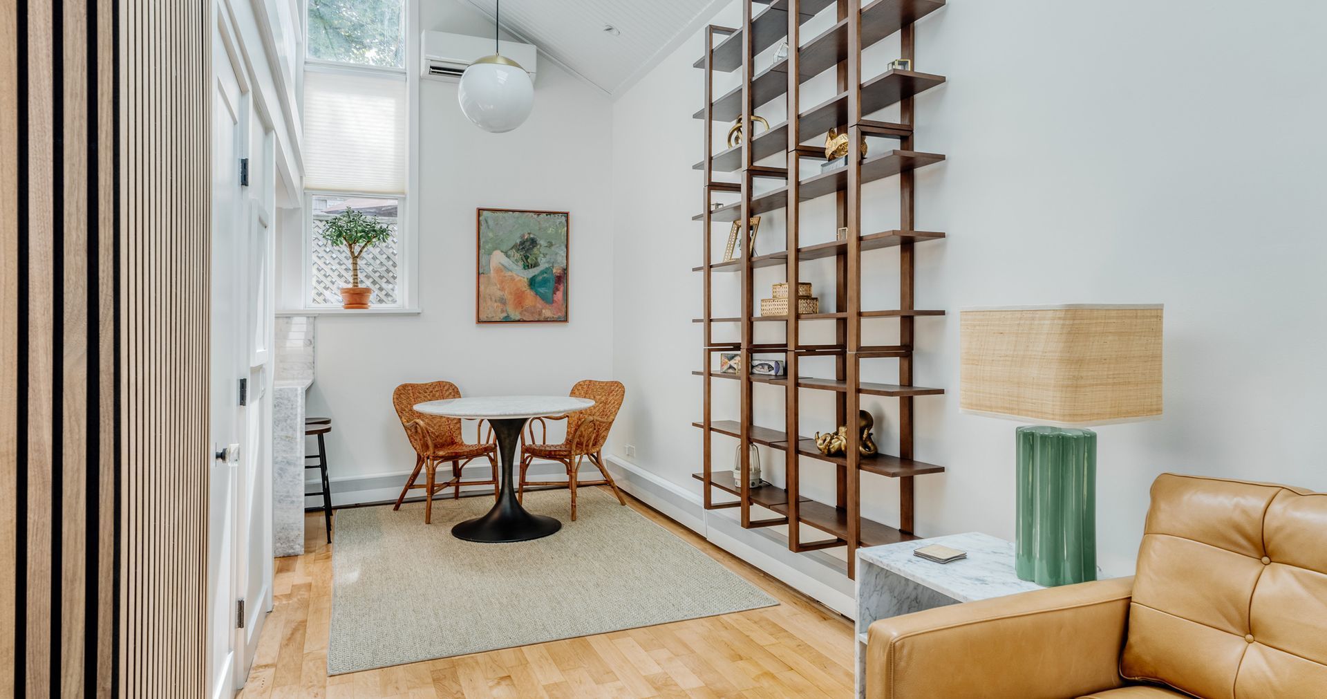 A living room with a couch, table, and chairs.