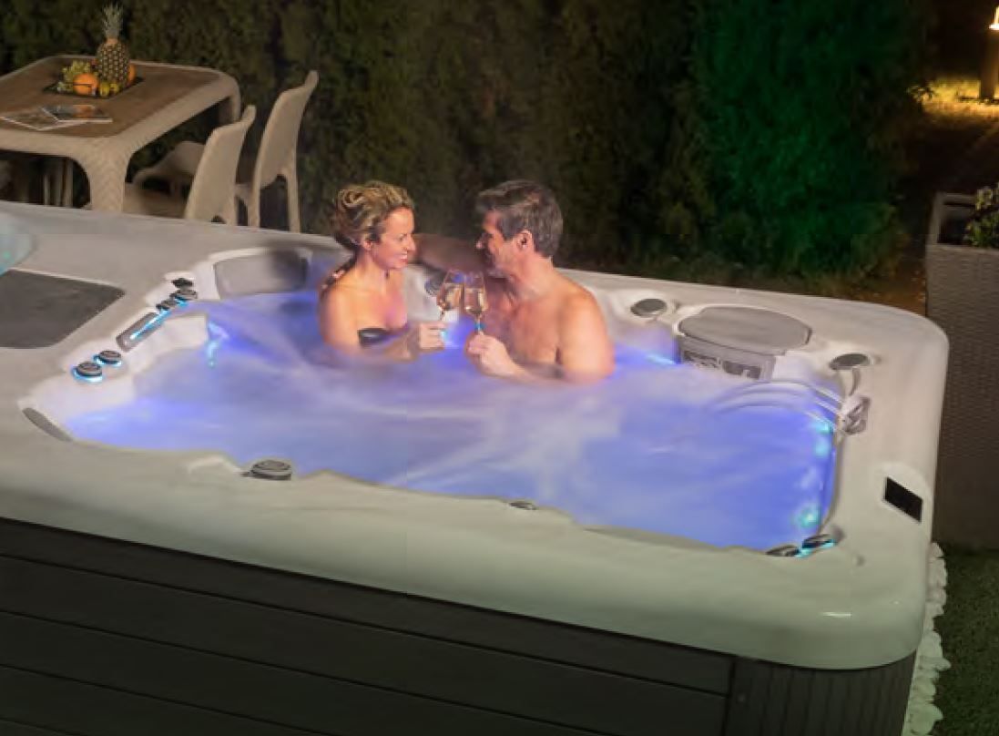 A man and a woman are sitting in a hot tub.