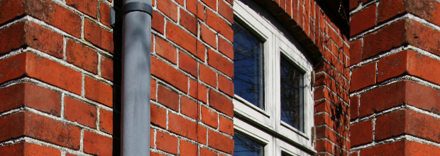 Brick house gutter window