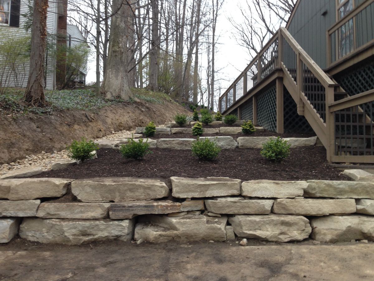 A stone wall with stairs leading up to a deck