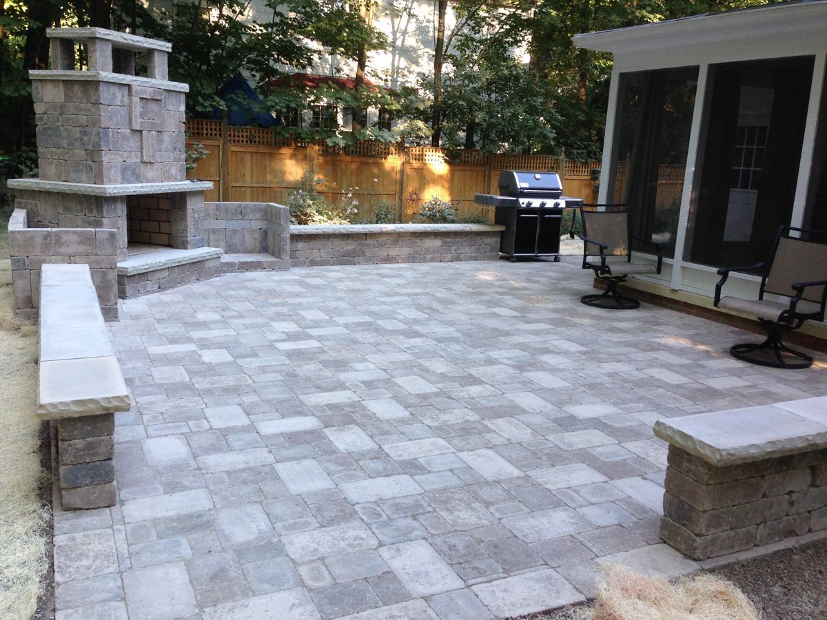 A patio with a fireplace and a grill