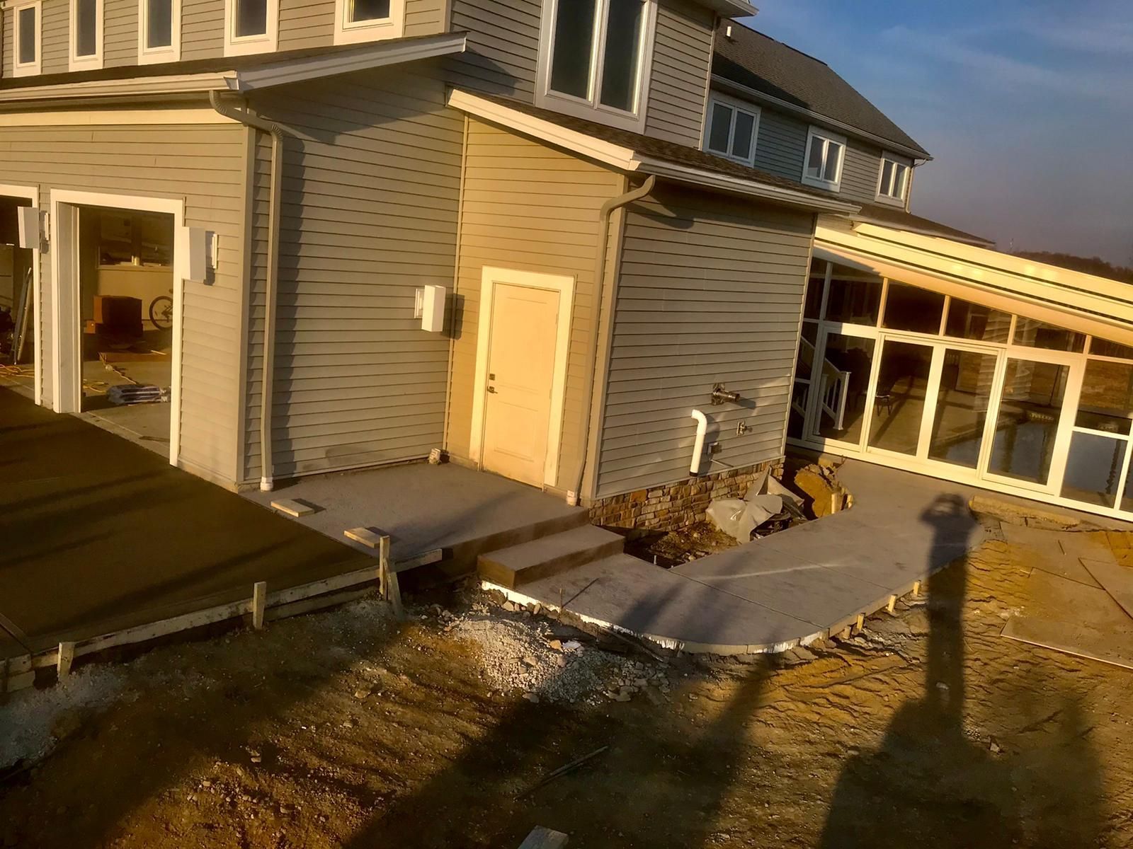 A house with a concrete walkway in front of it