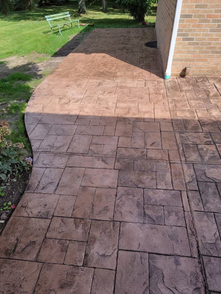 A brick building with a concrete walkway leading to it.