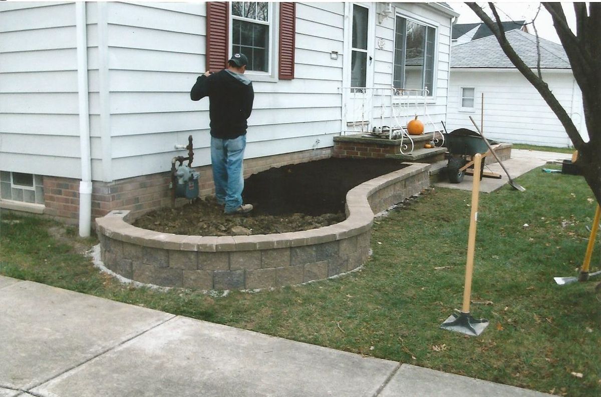 A man is standing in front of a white house