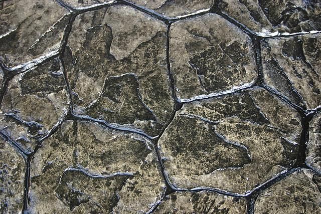 A close up of a stone wall with a pattern of rocks