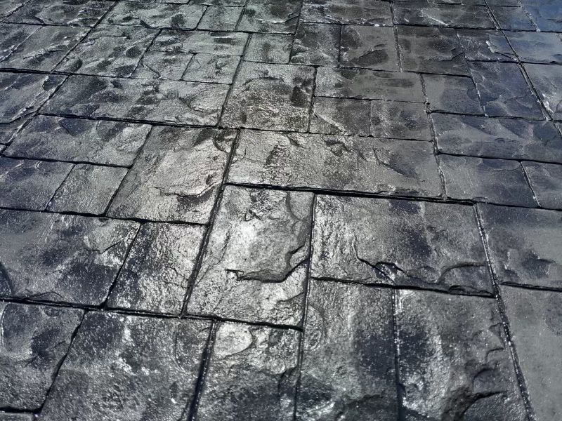 A black and white photo of a brick floor.