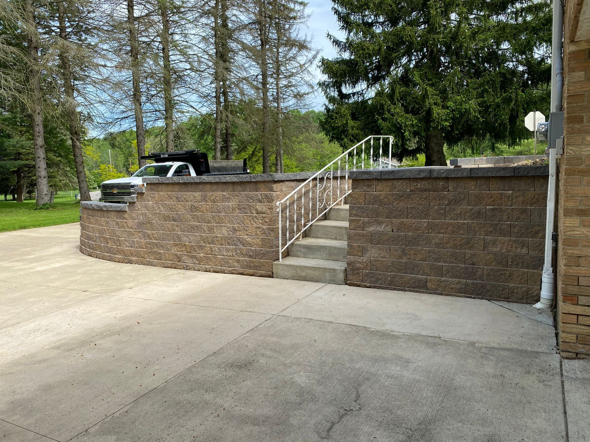 There is a brick wall with stairs leading up to it.