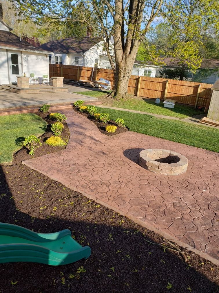 There is a fire pit in the middle of the backyard.