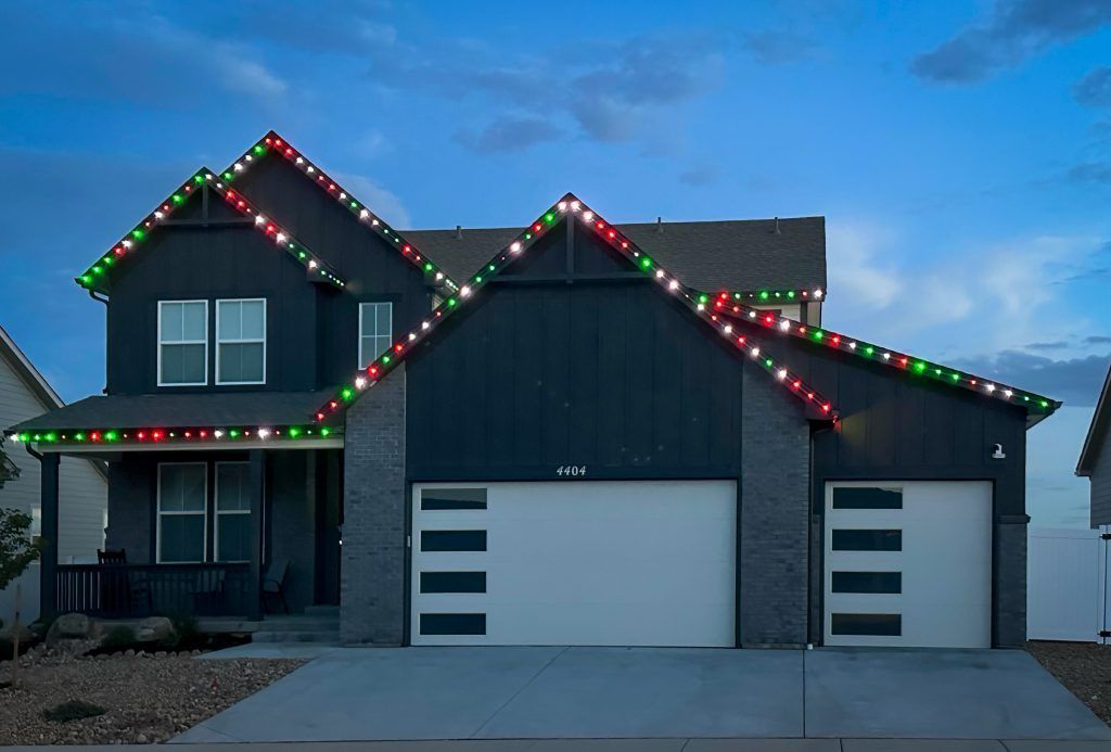House with Christmas lights on the roof at dusk