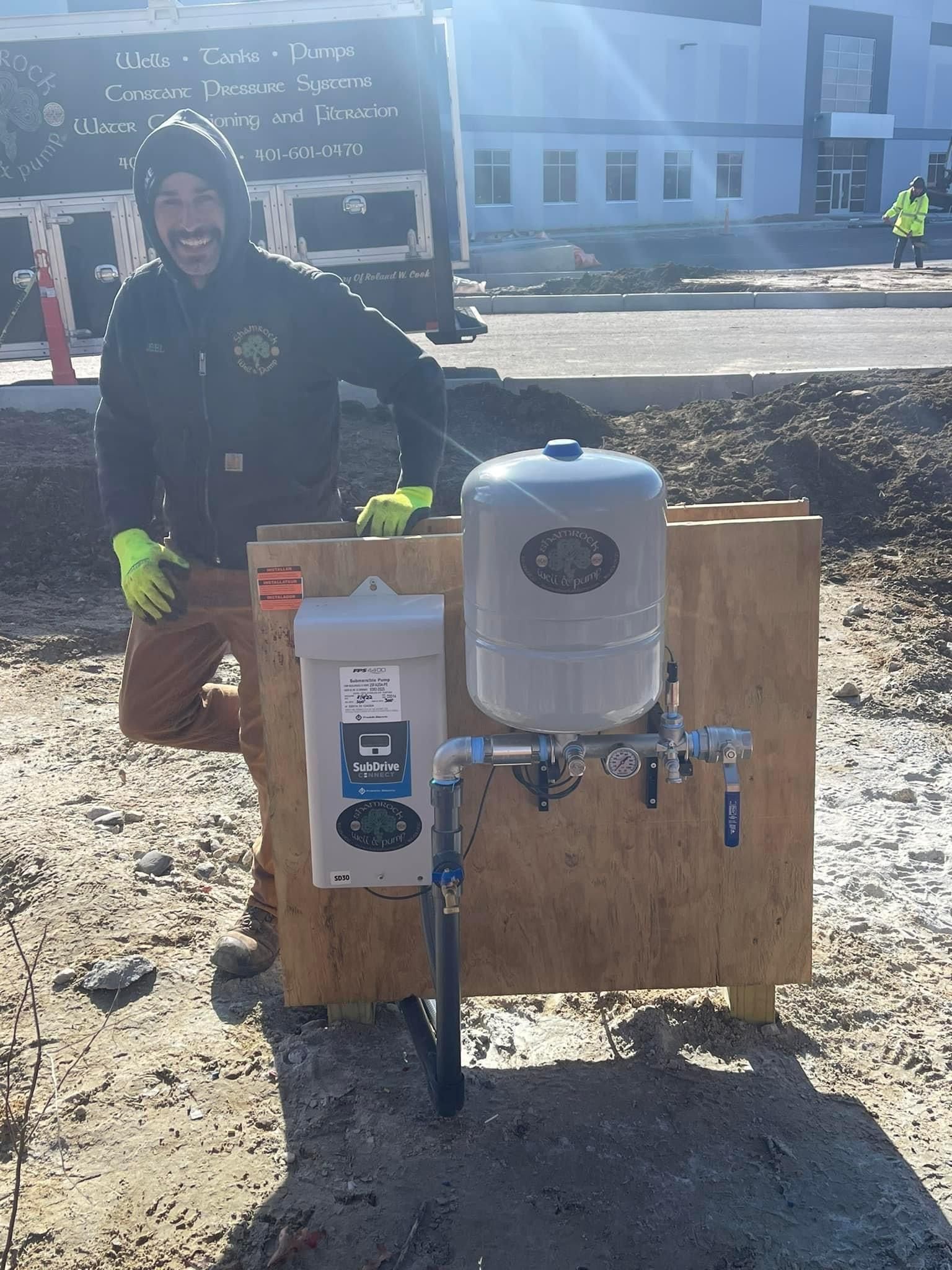 A man standing beside the water well