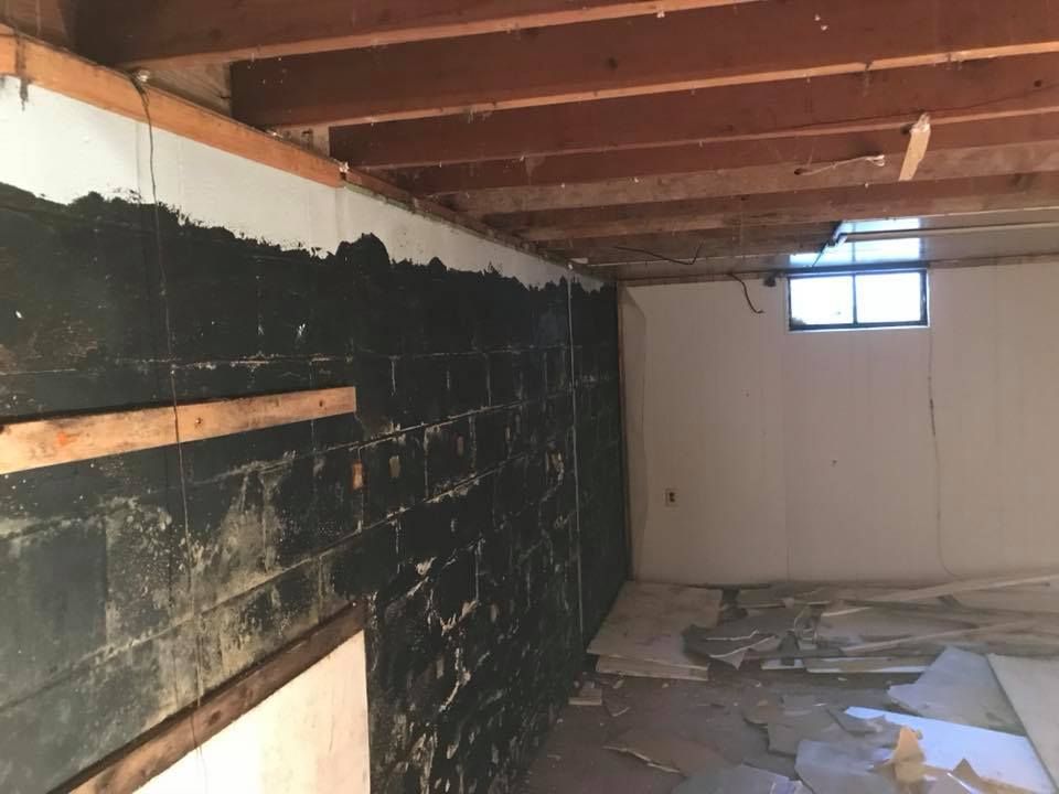 A basement with a brick wall and a window.