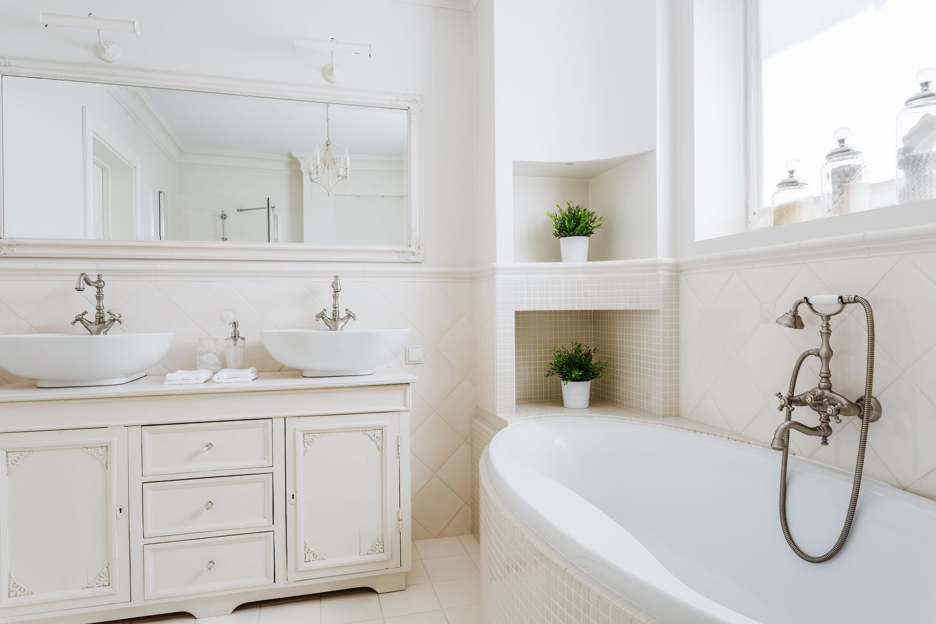 White bathroom with vanity, two sinks, oval tub, and decorative shelving.