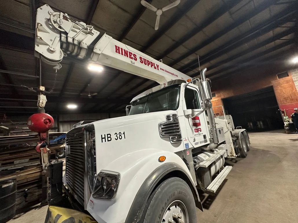 A white crane truck labeled