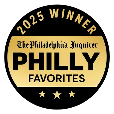 A circular black and gold Philadelphia Inquirer 2025 Winner Philly Favorites badge with three stars at the bottom.