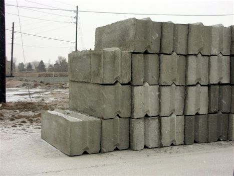 A pile of concrete blocks are stacked on top of each other on the ground