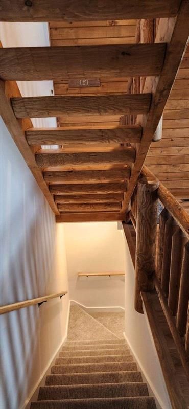 A wooden staircase leading up to the second floor of a house.