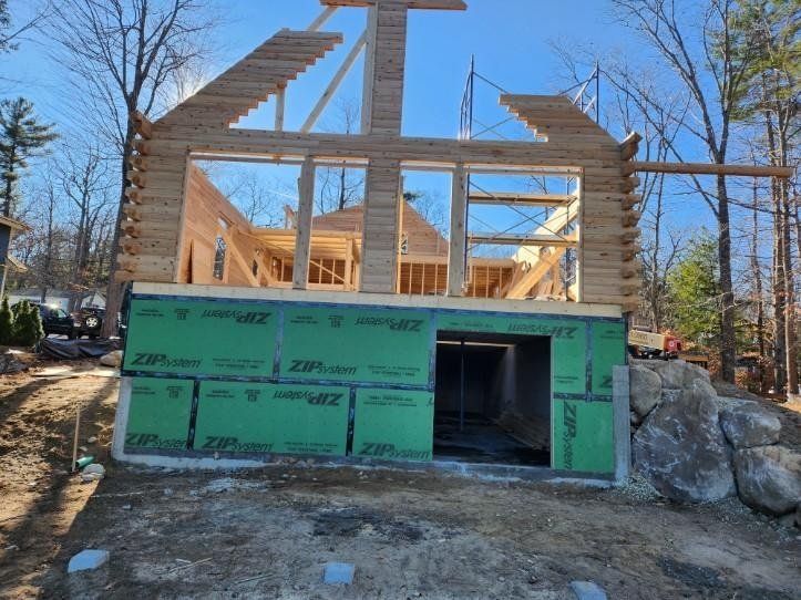 A log cabin is being built in the woods