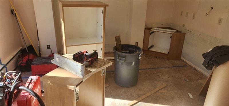 There is a trash can in the middle of the room.