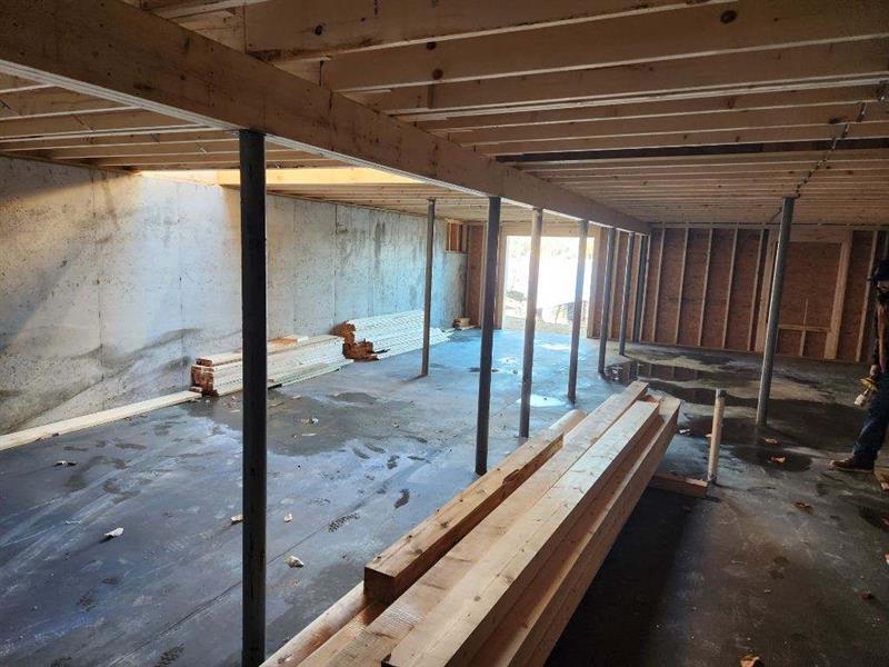 A man is standing in a room with a lot of wood in it