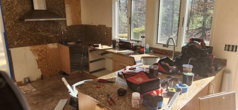 A kitchen under construction with a lot of tools on the counter.