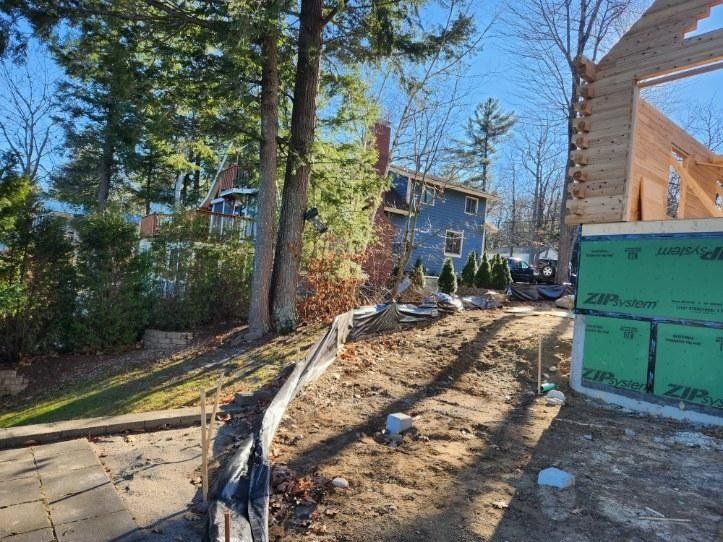 A house is being built in the backyard of a house.