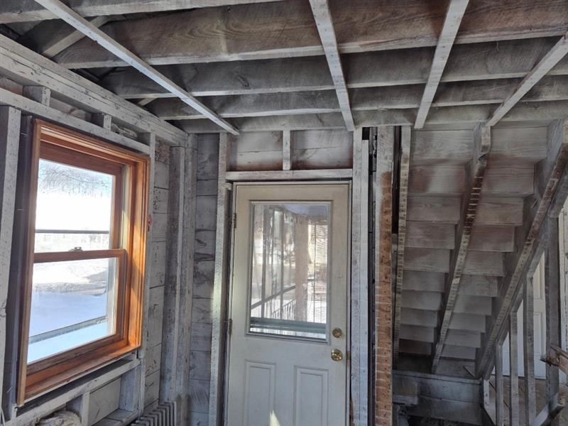 A room with a door and stairs in it