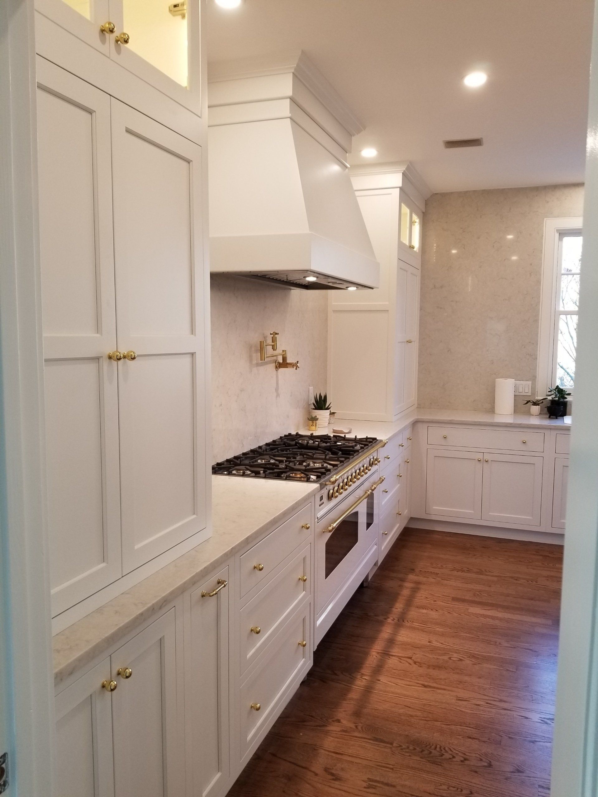 white kitchen with white range hood cover