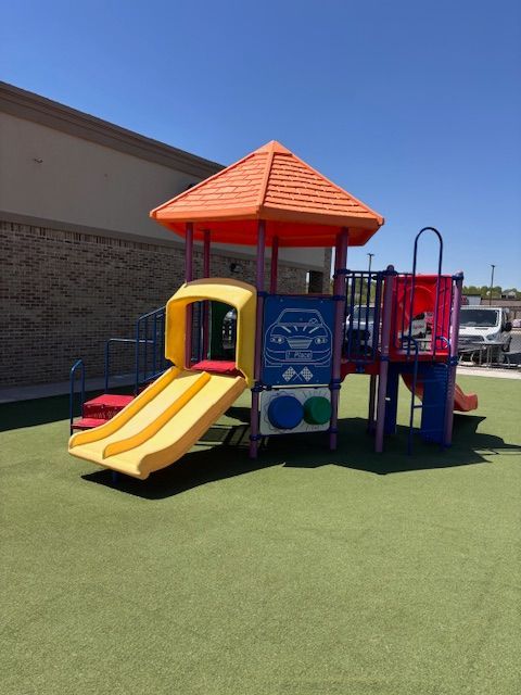 A colorful playground with a slide and stairs
