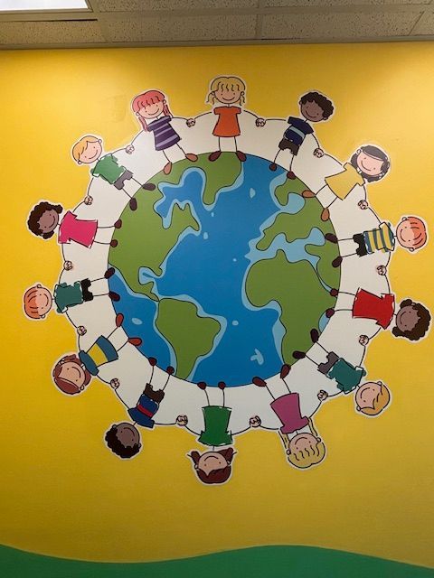 A painting of children holding hands around a globe