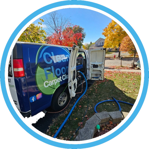 Blue Carpet Clean truck with open doors and hoses on a sunny autumn lawn.