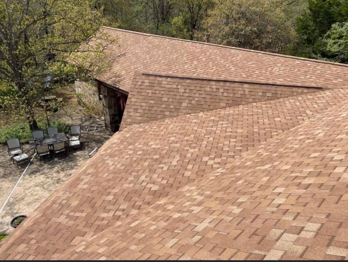 An aerial view of a house with a brown roof