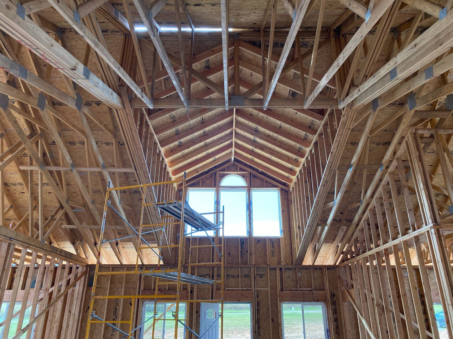 The inside of a house under construction with a ladder