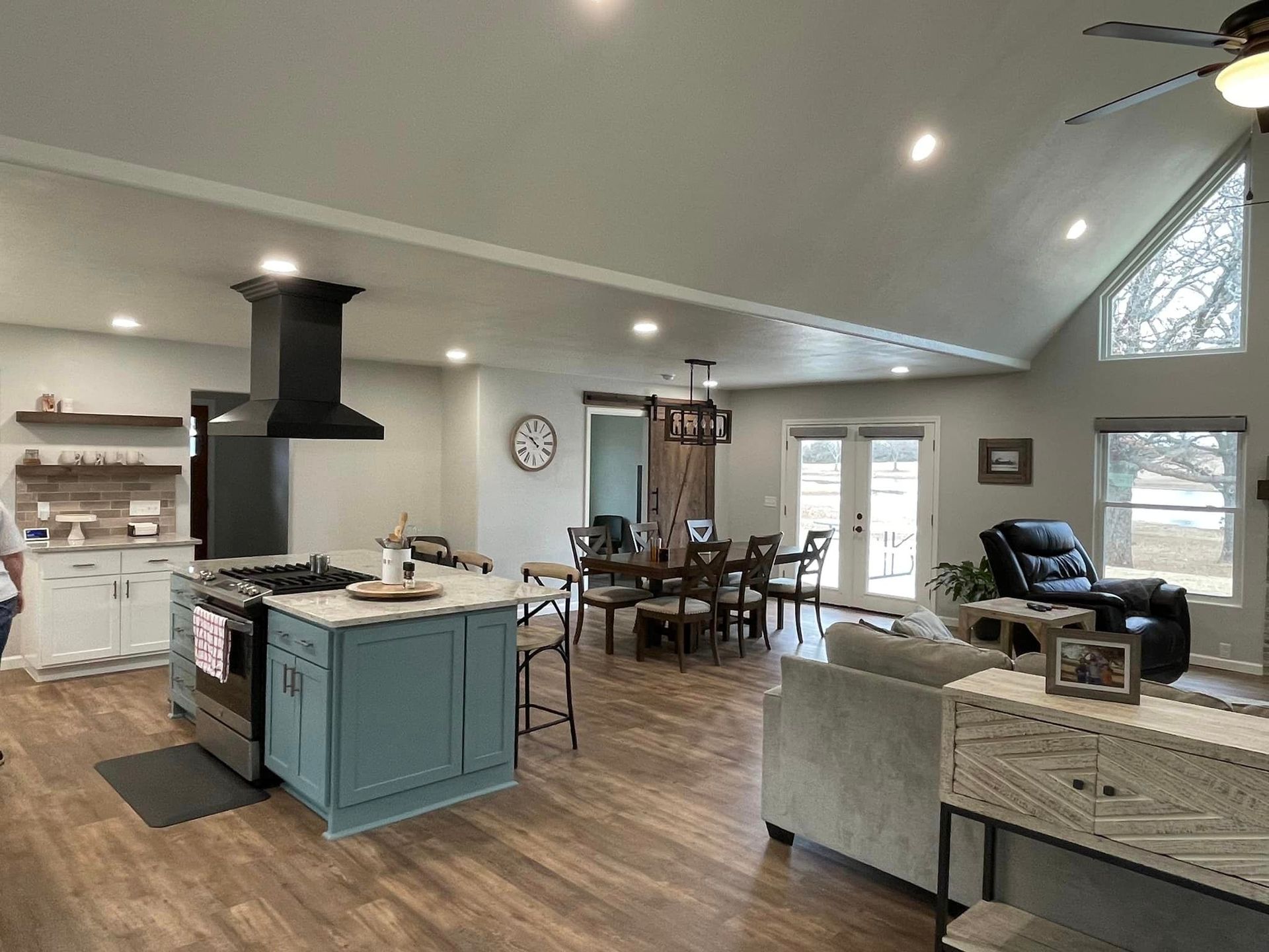 A kitchen, dining room, living room and a ceiling fan in a house