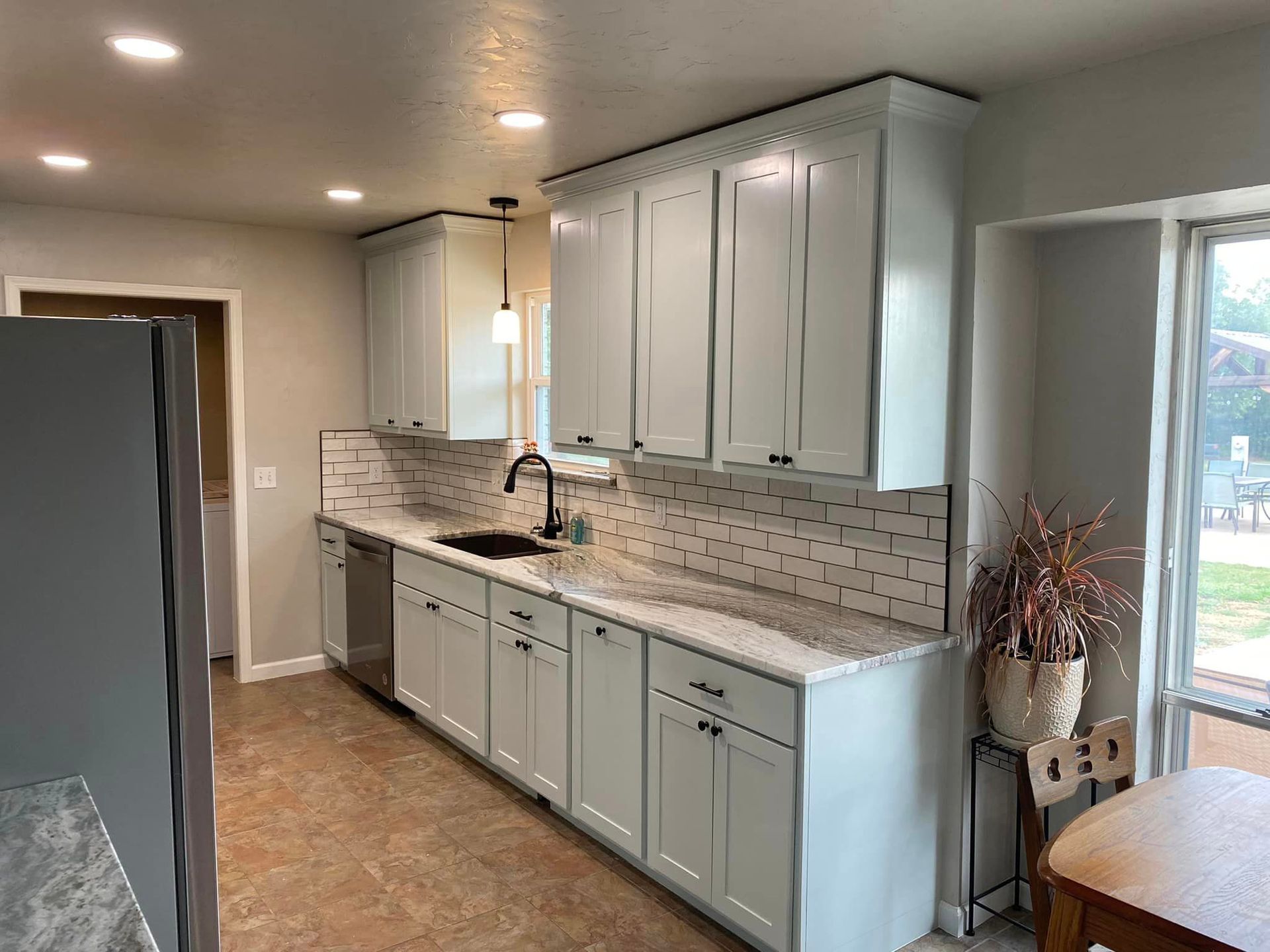 A kitchen with white cabinets