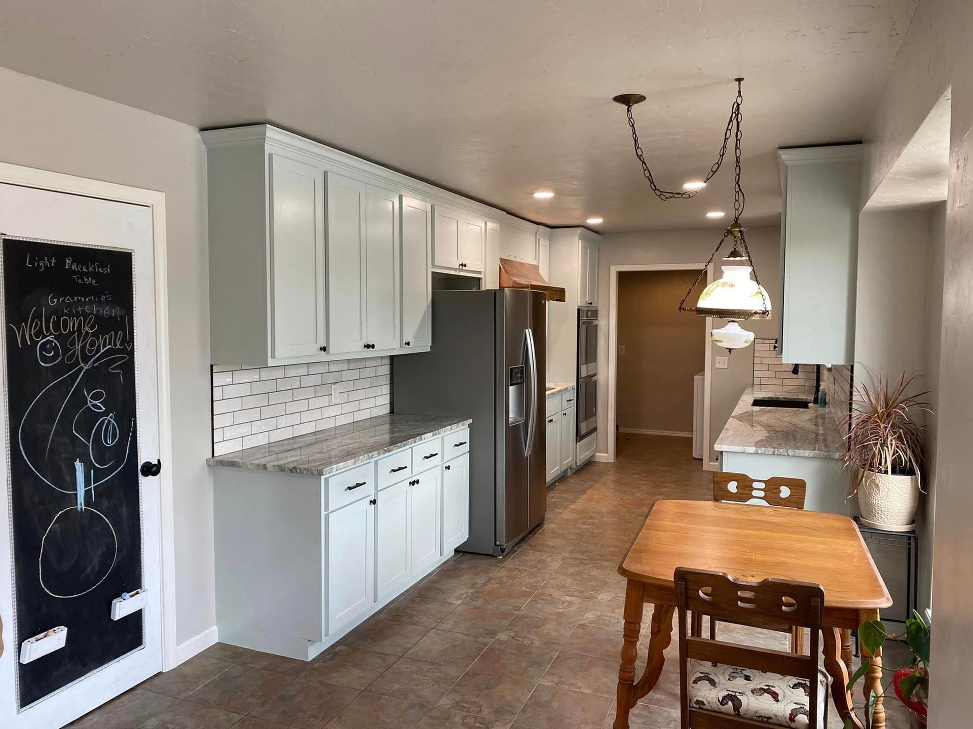 A kitchen with white cabinets #2