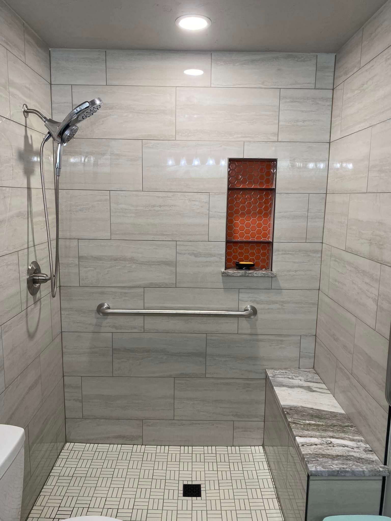 A bathroom with a walk in shower and a toilet