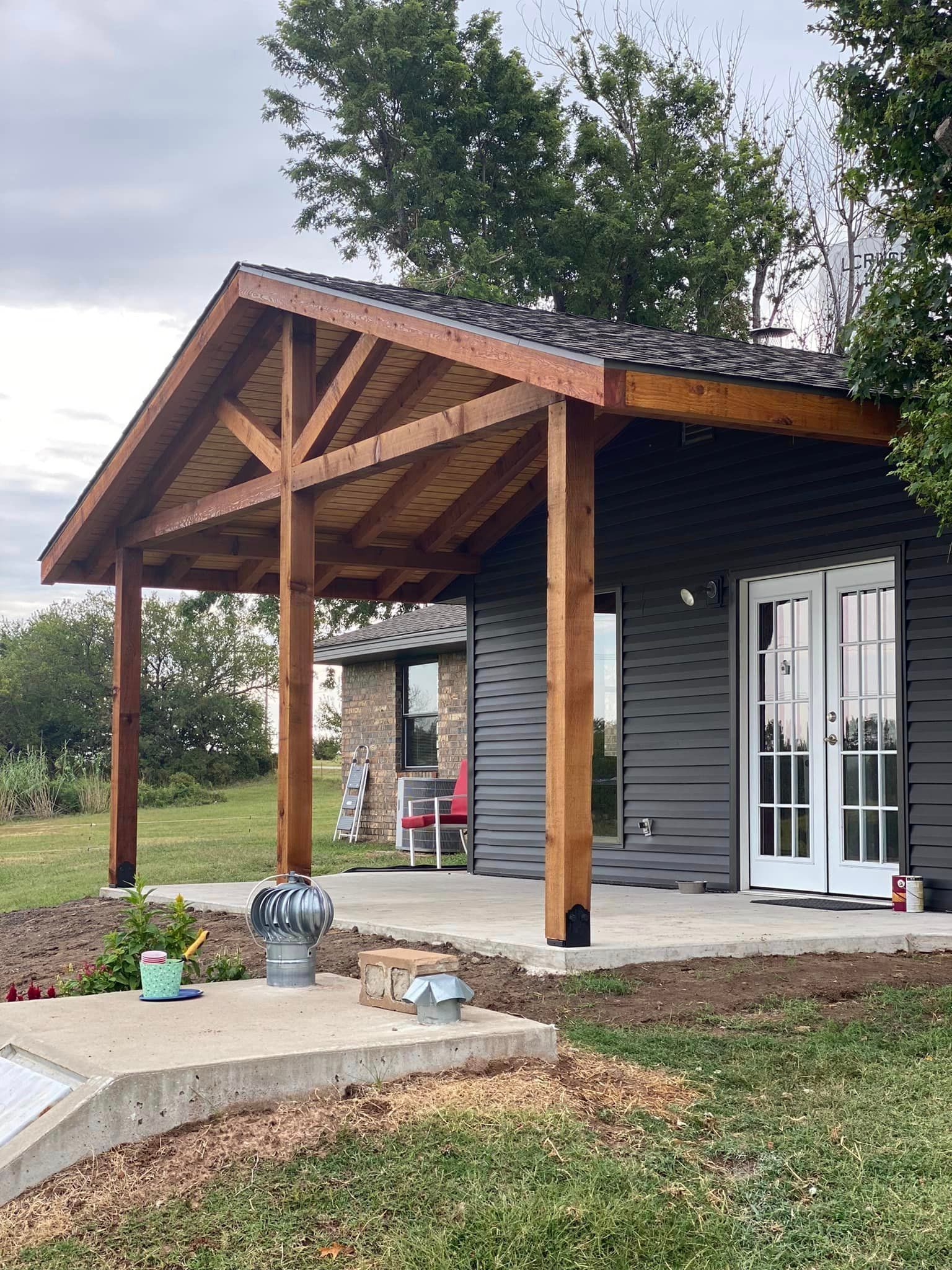 A small house with a wooden porch and french doors