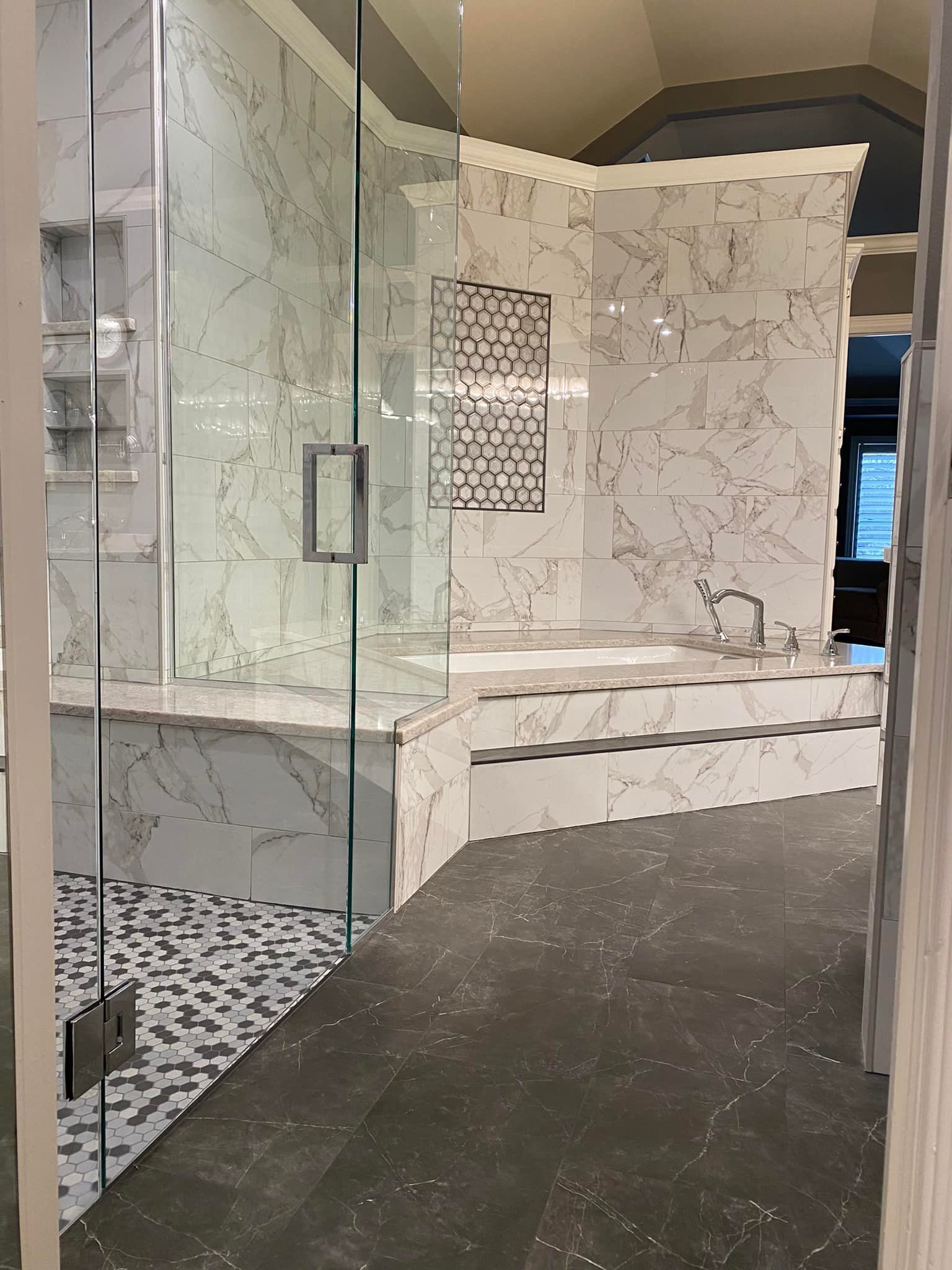 A bathroom with a bathtub and a walk in shower