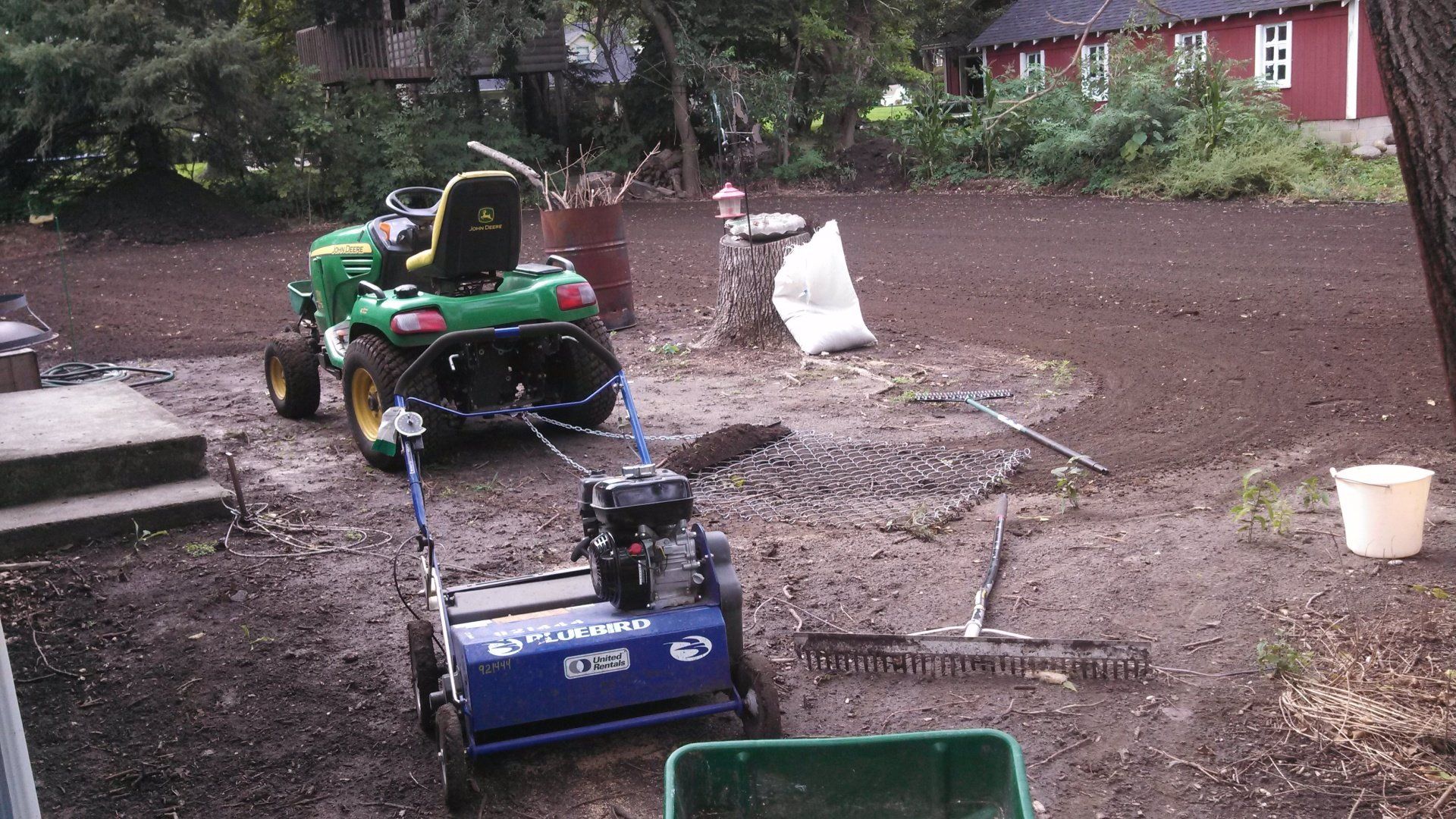 A lawn mower is parked in the dirt