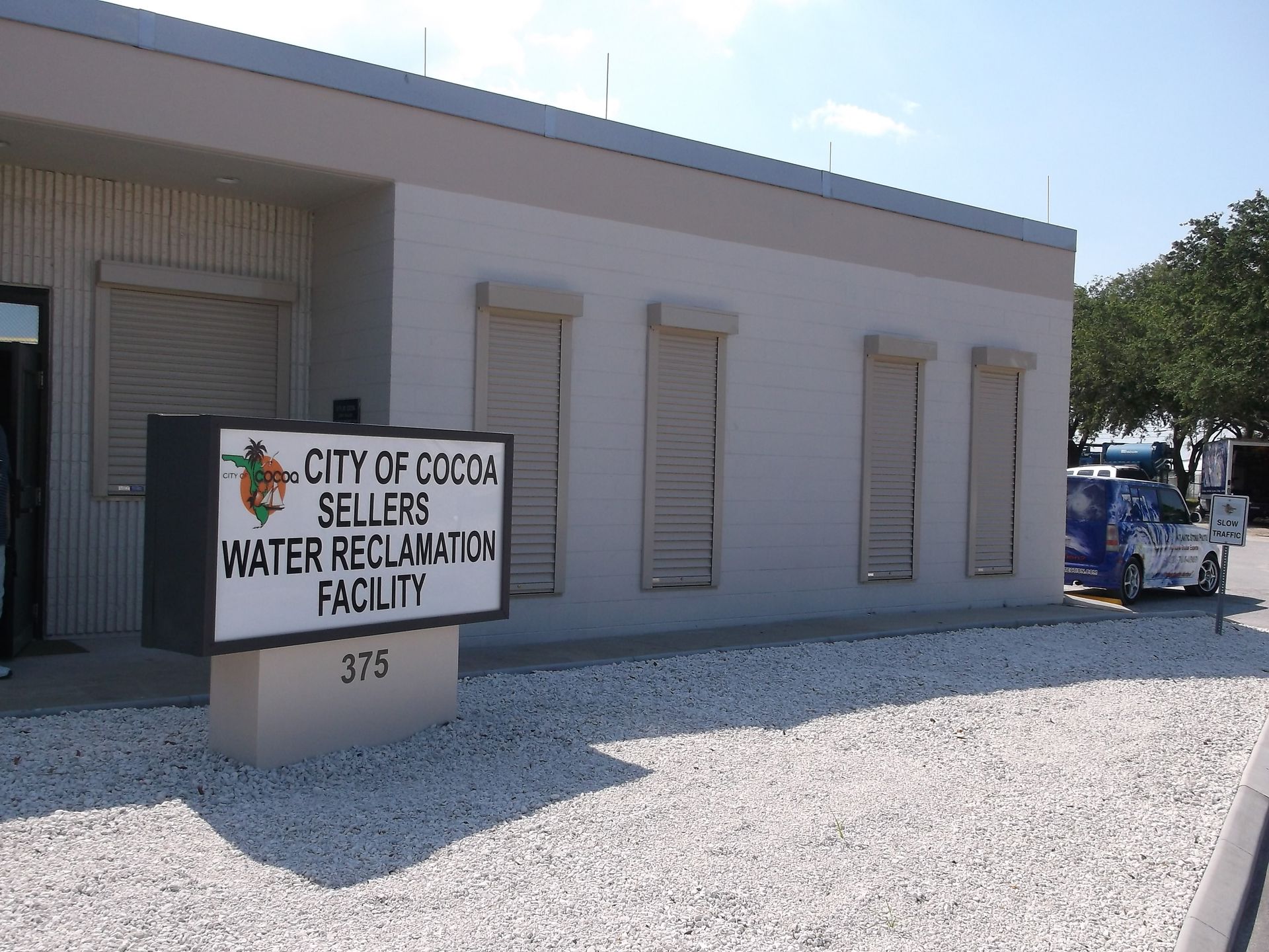 City of Coos Bay water reclamation facility sign beside a beige utility building.