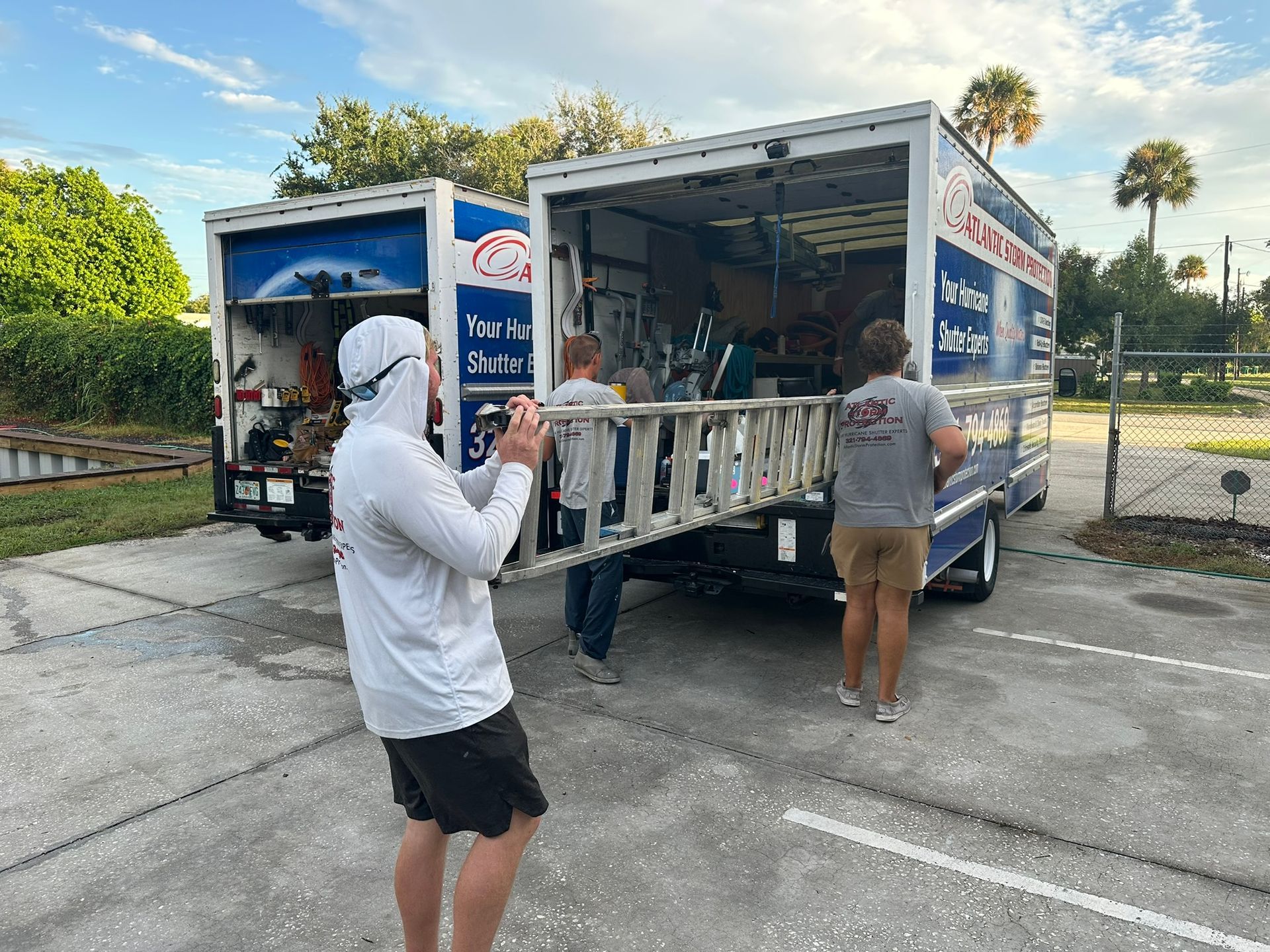 Workers unload supplies from a Pepsi truck in a parking lot