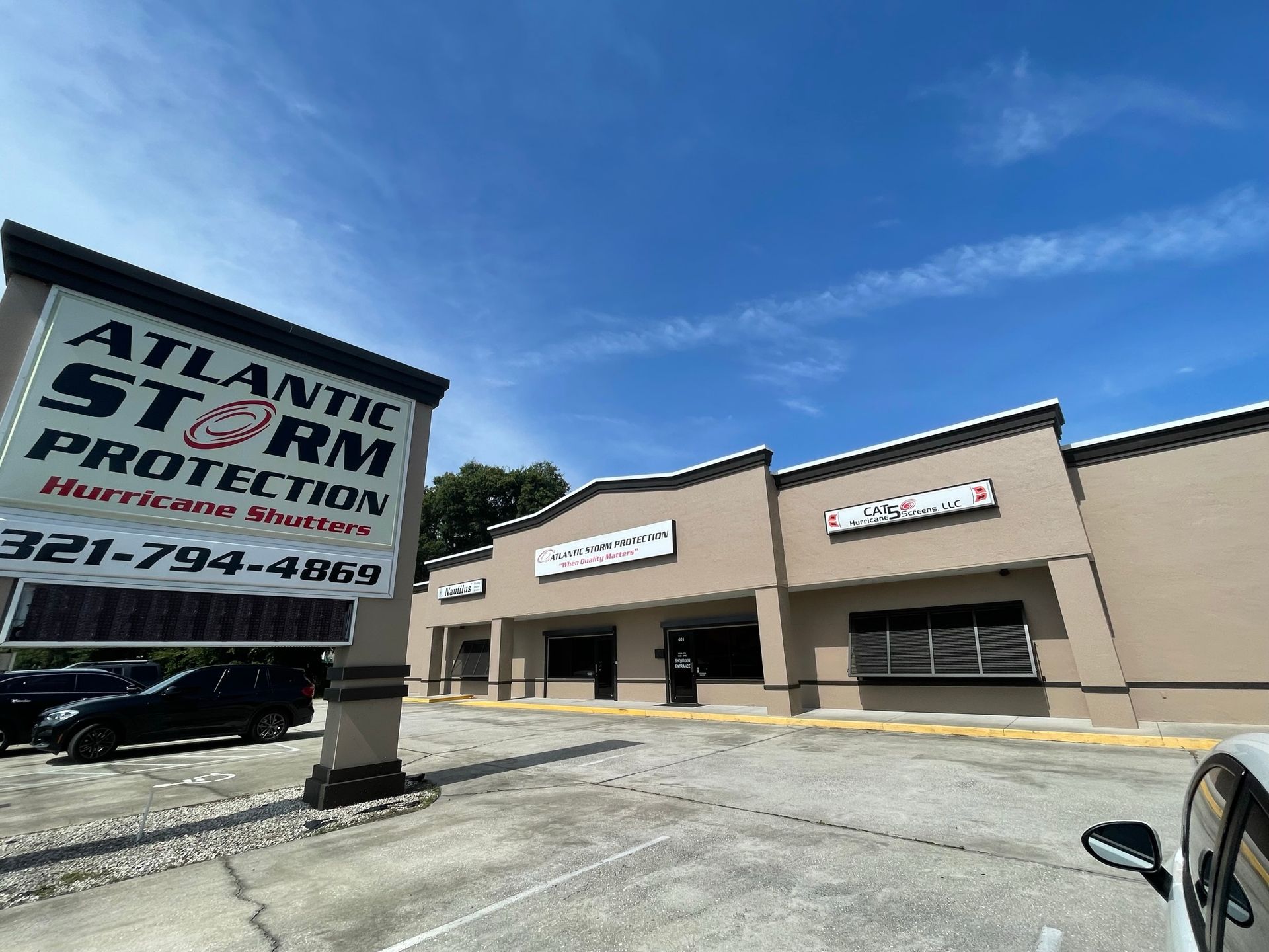 Atlantic Self Storage Protection storefront with tan building and large sign under a blue sky