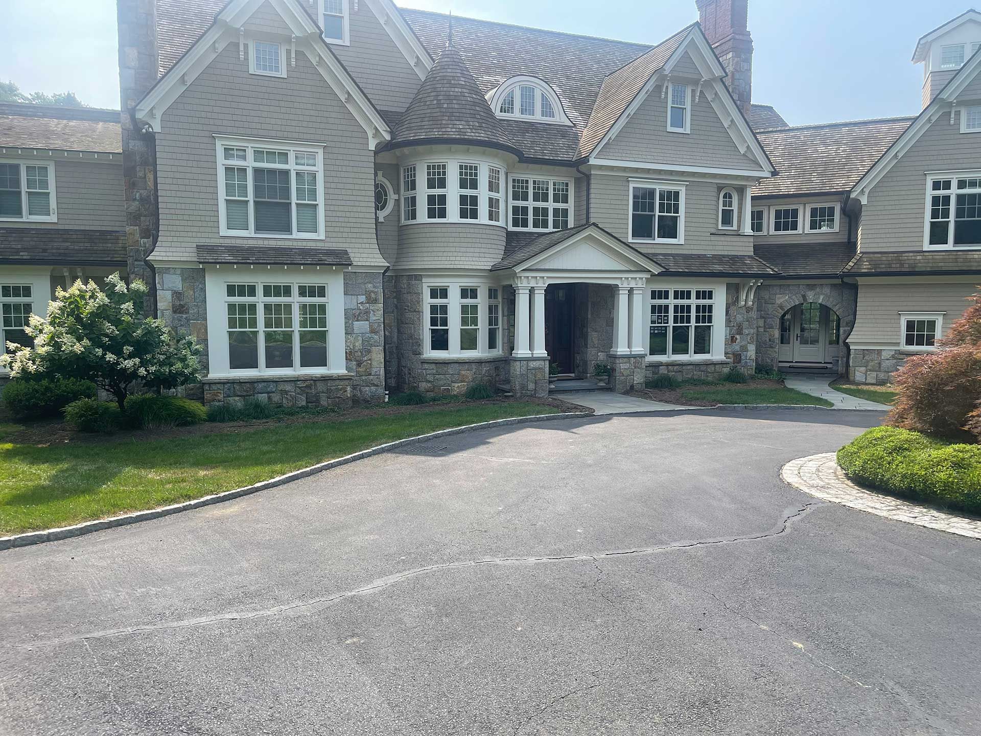 a large house with a lot of windows and a driveway