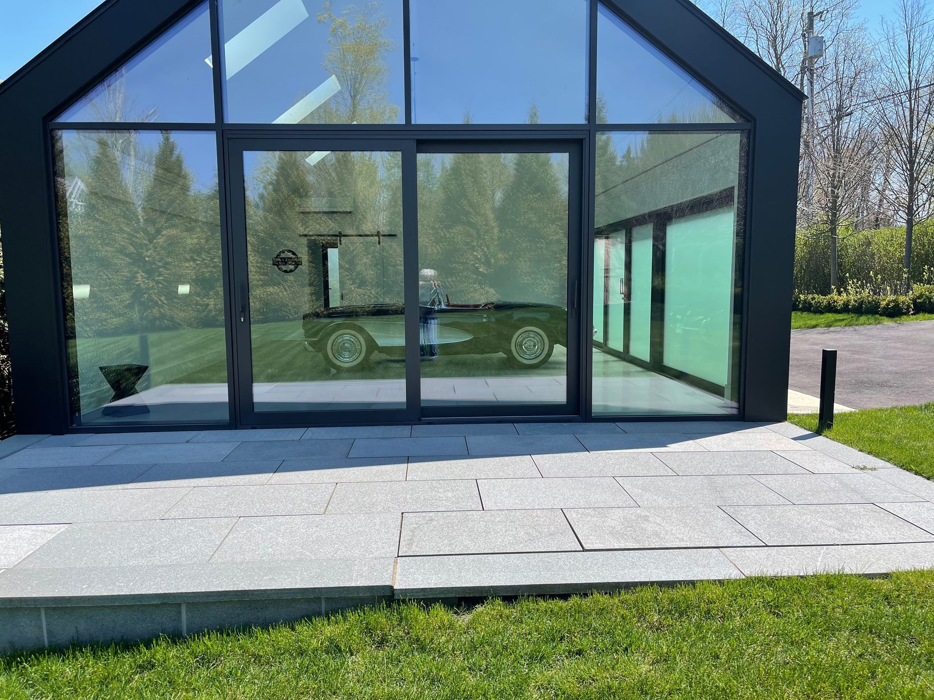 a glass building with stonework in front of it