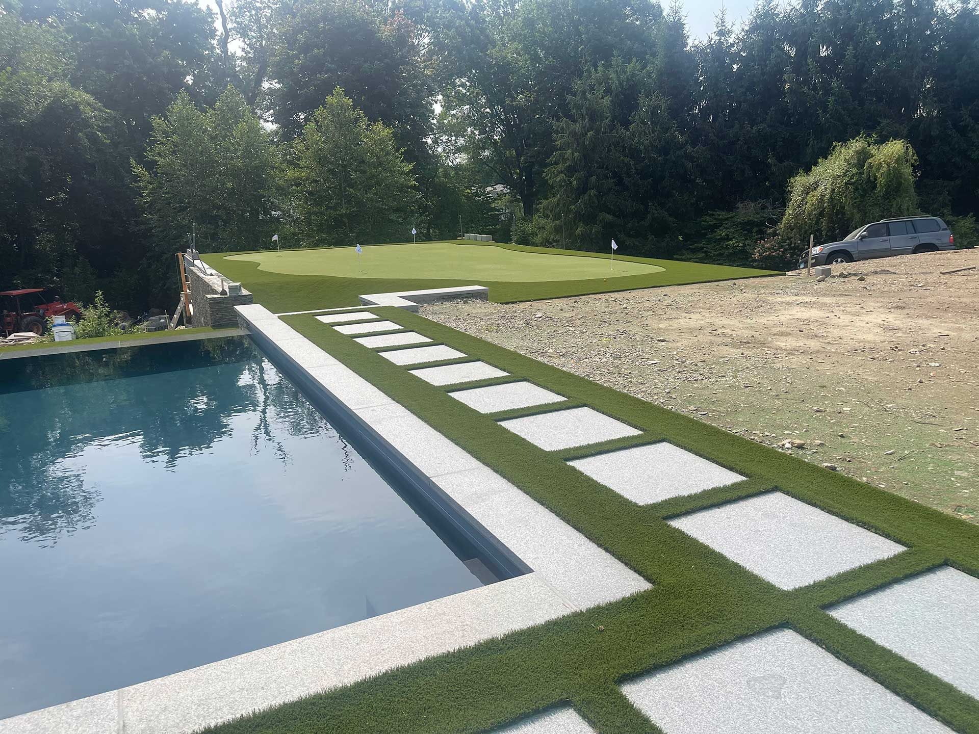 a swimming pool with a path leading to it
