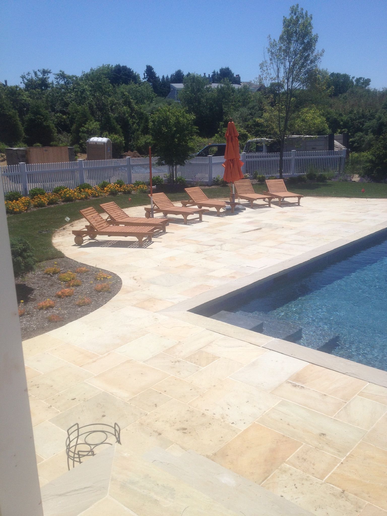 a swimming pool with a lot of chairs and umbrellas