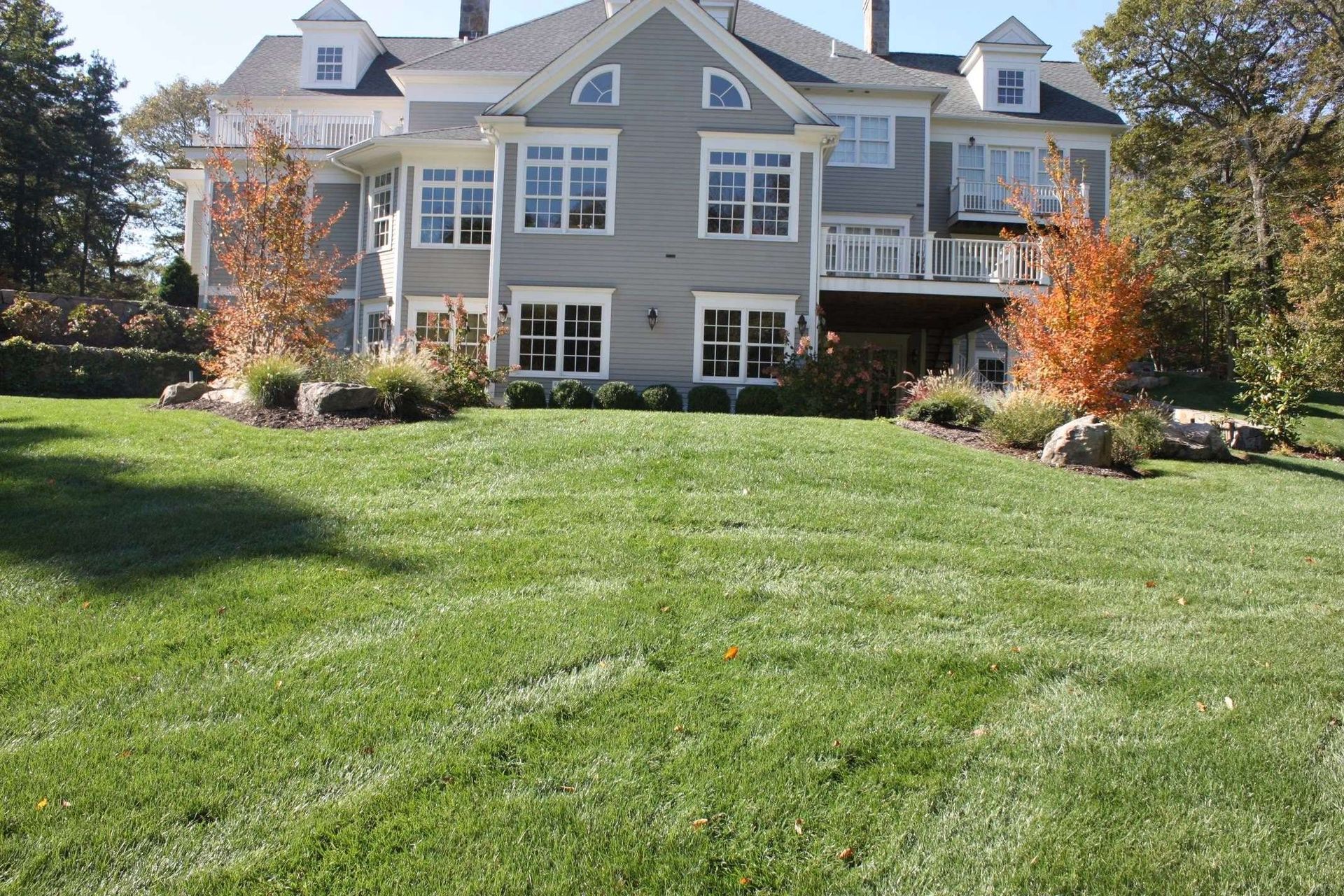A large house with a lush green lawn in front of it
