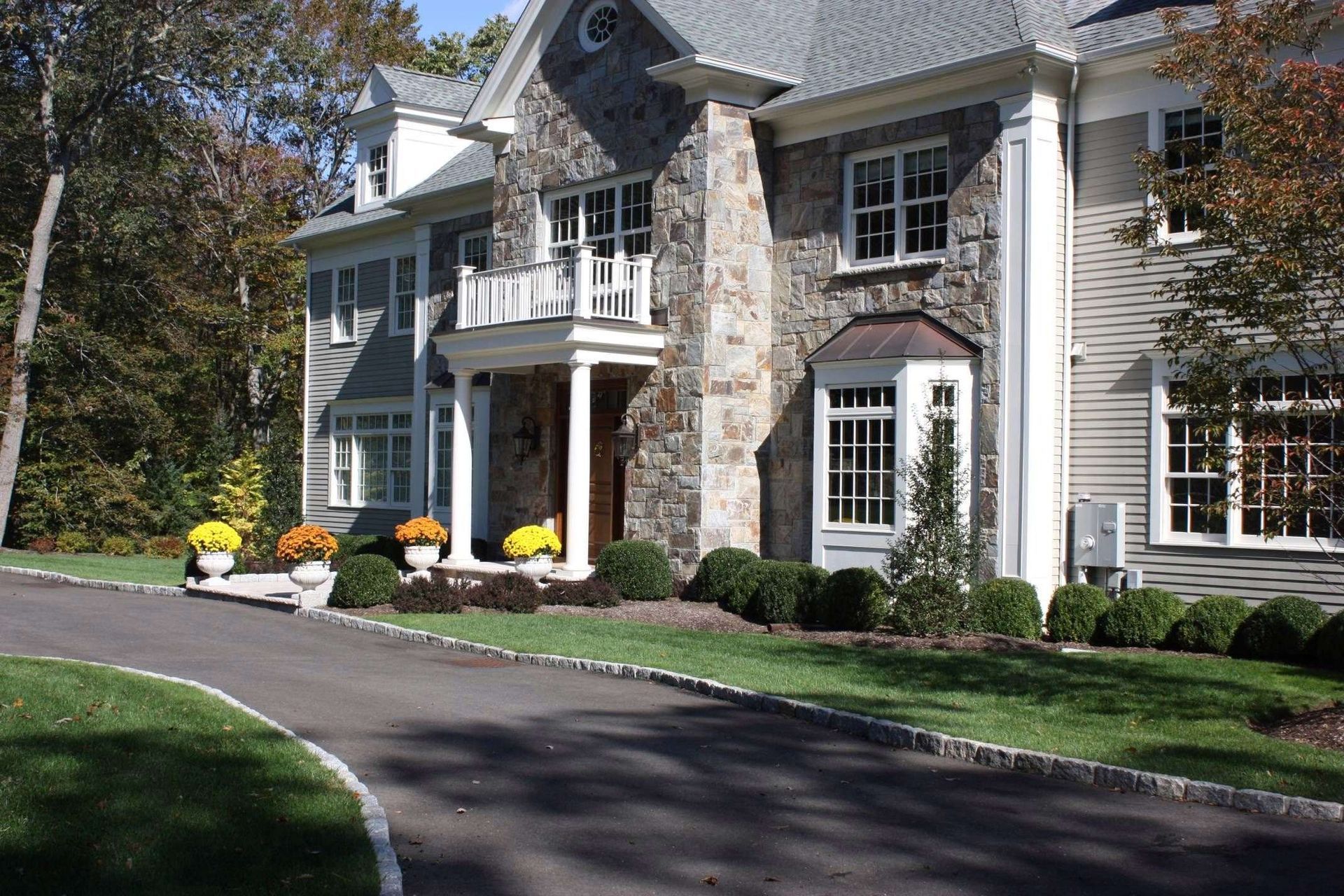 A large house with a driveway leading to it